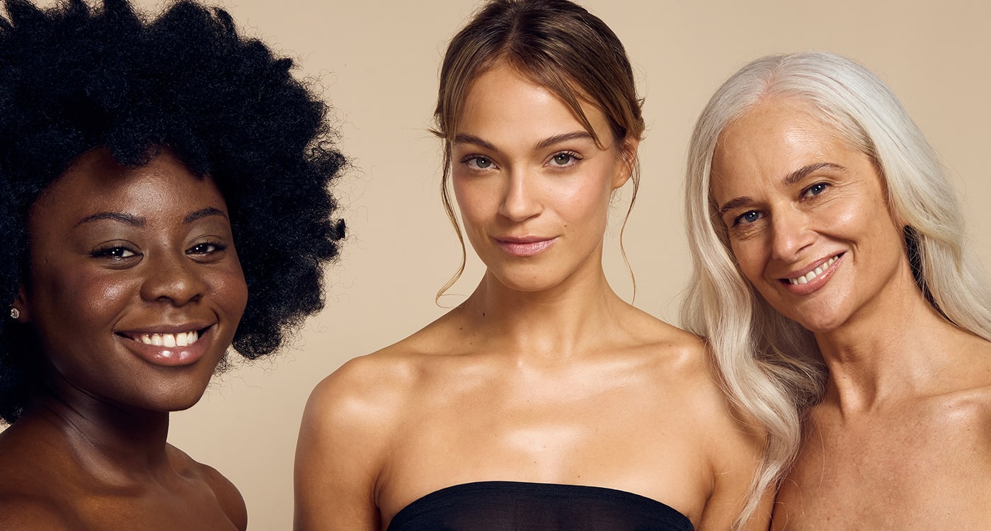 Female models of various ages and skin tones showcasing their glowing skin achieved with Self Glow by James Read's inclusive sunless tanning skincare products, suitable for all skin types and tones.