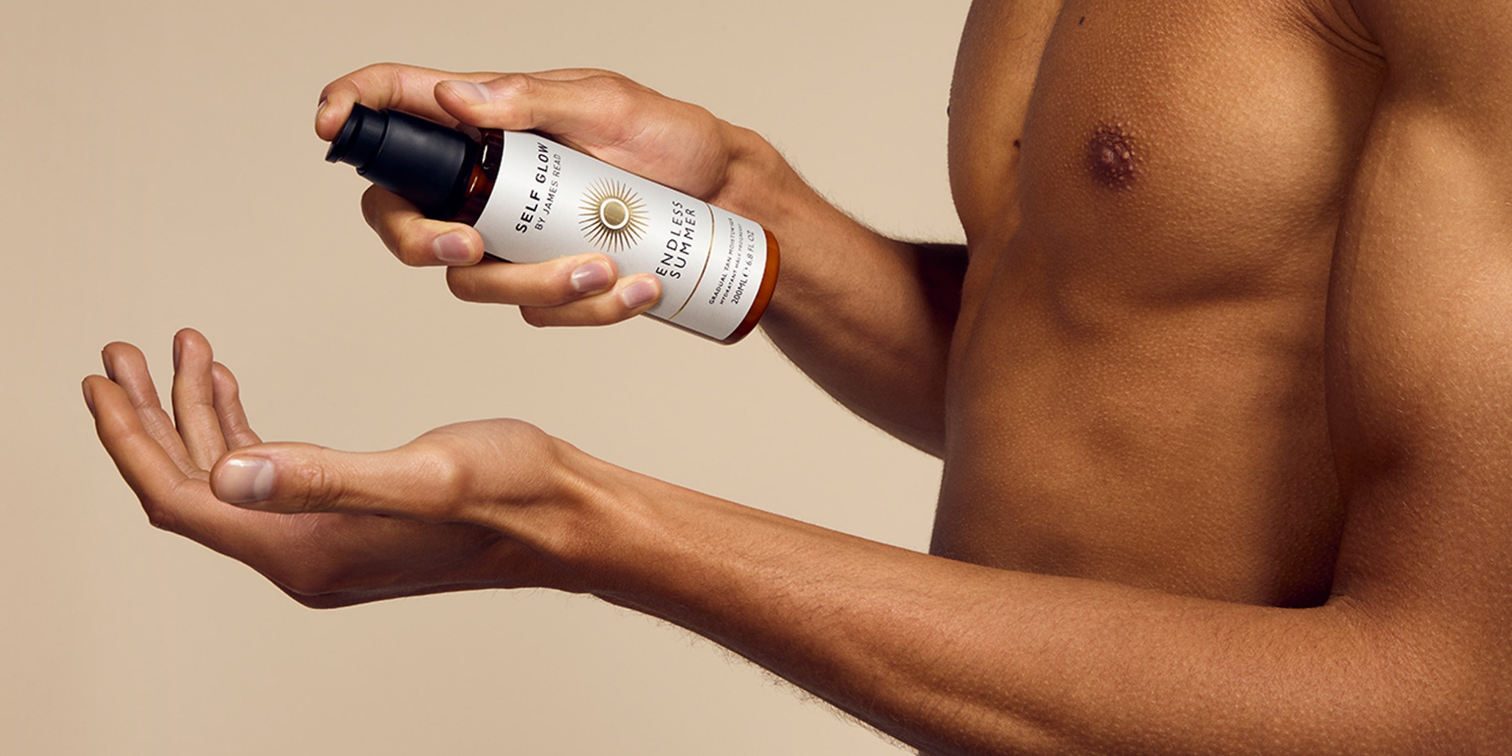 A black male model demonstrating the perfect glow routine with Self Glow by James Read, pumping out the Endless Summer Gradual Body Moisturiser, ready to apply for a glowing, hydrated body.